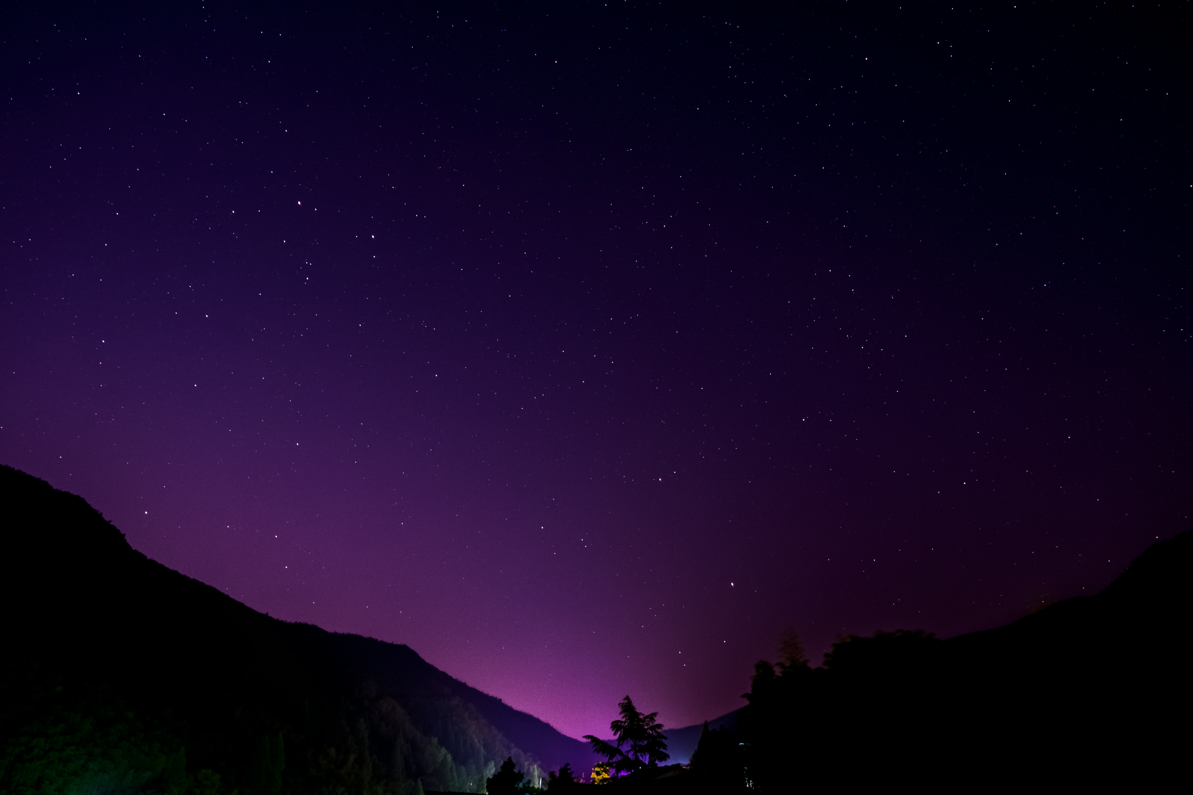 Purple starry night sky over mountains - electrical services contact background