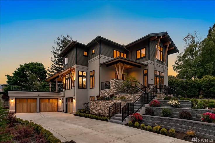 Luxury home electrical project completion showing beautiful exterior lighting installation at dusk with professional landscape and architectural lighting