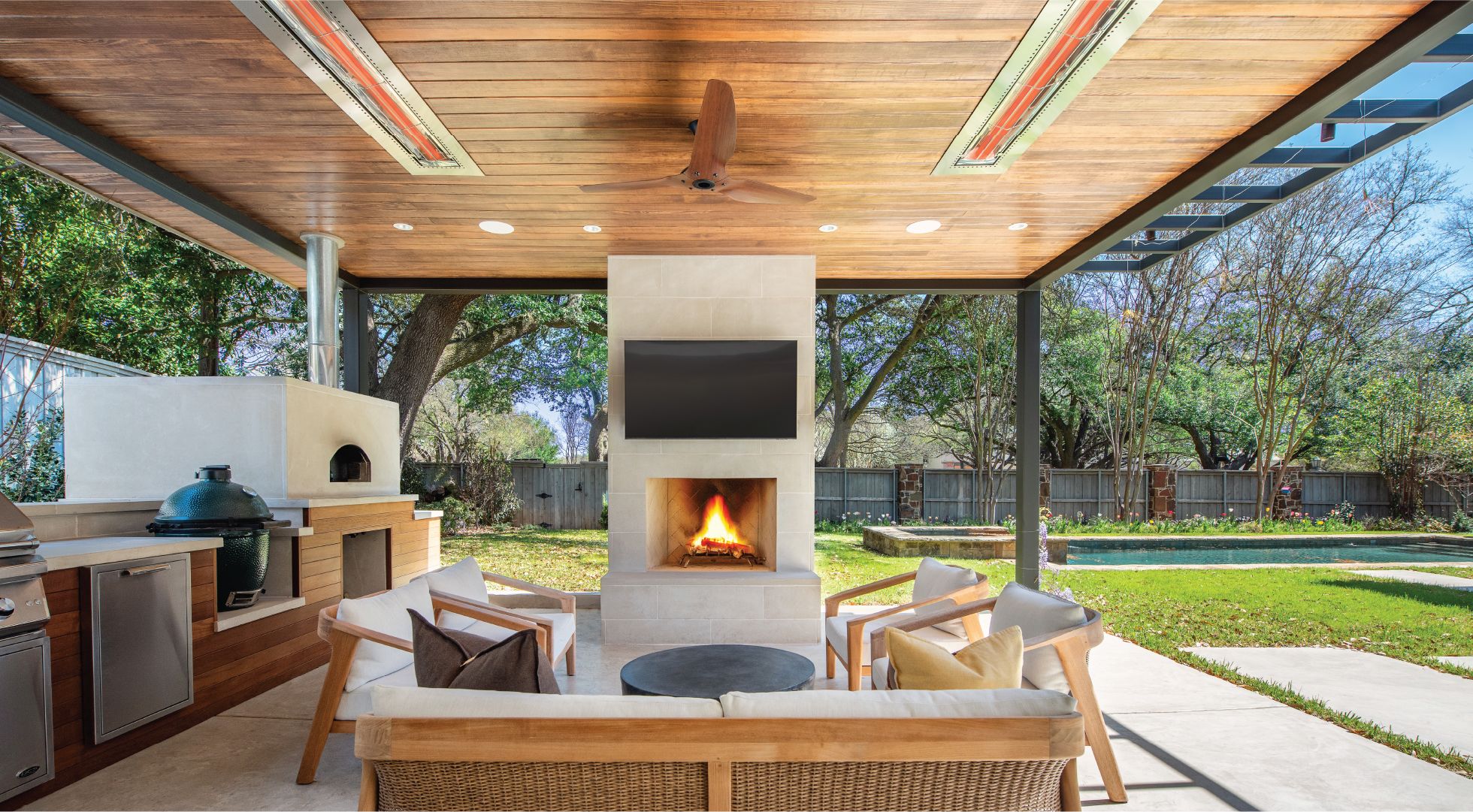 Luxury outdoor patio with integrated infrared heaters by Astro Electric in Bellevue, featuring ceiling-mounted heating elements, outdoor kitchen, and professional installation